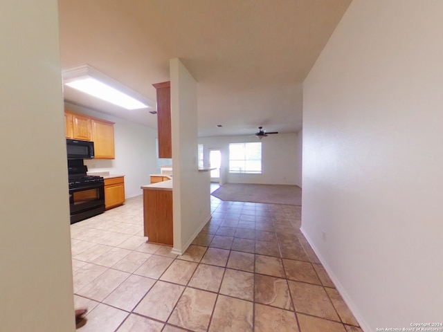 kitchen with light tile patterned floors, ceiling fan, and black appliances