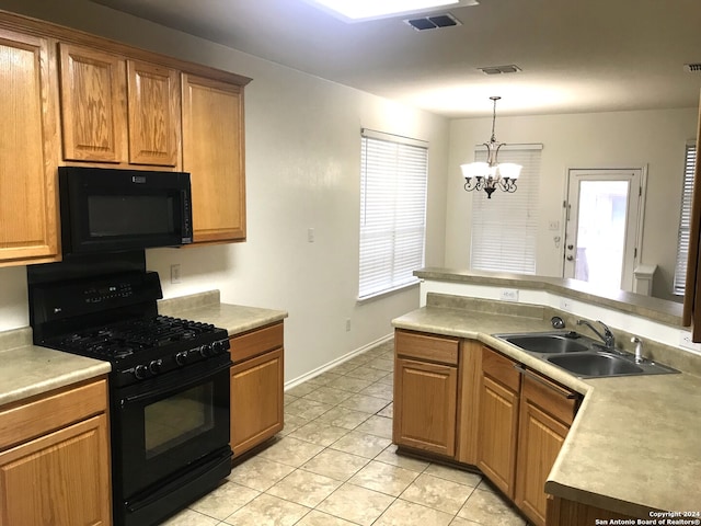 kitchen featuring black appliances, hanging light fixtures, plenty of natural light, sink, and an inviting chandelier