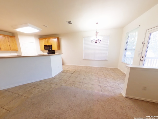 unfurnished dining area featuring a notable chandelier and light colored carpet