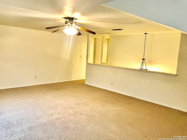 carpeted spare room with ceiling fan