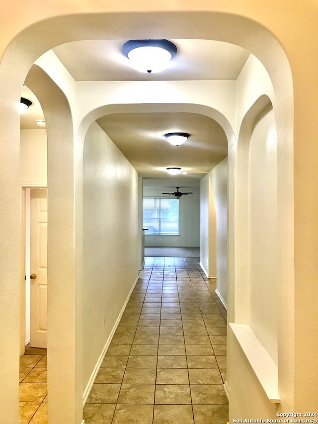 hall featuring light tile patterned flooring