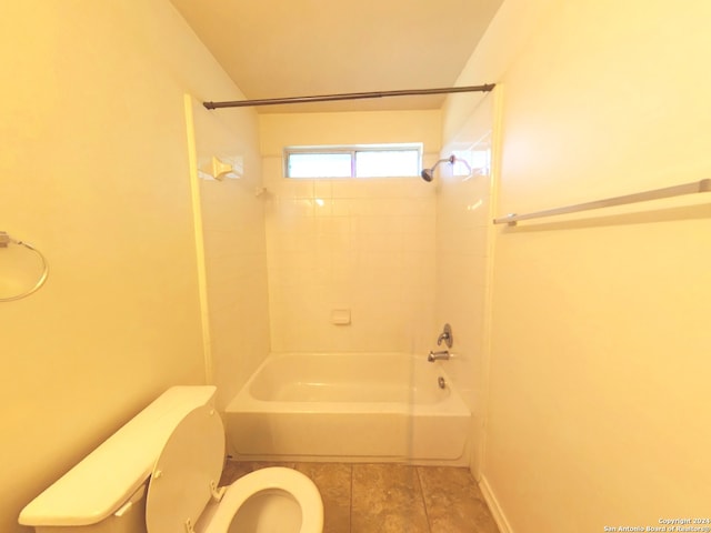 bathroom with tile patterned floors, tiled shower / bath combo, and toilet