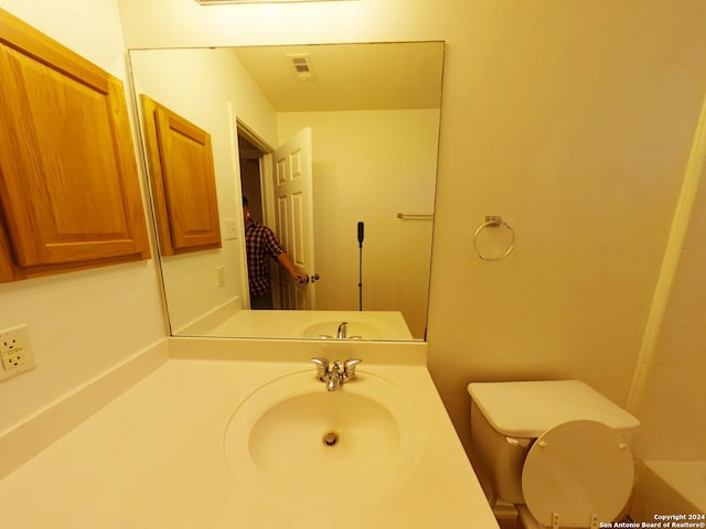 bathroom with vanity and toilet