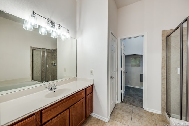 bathroom featuring vanity, a shower with shower door, and tile patterned floors