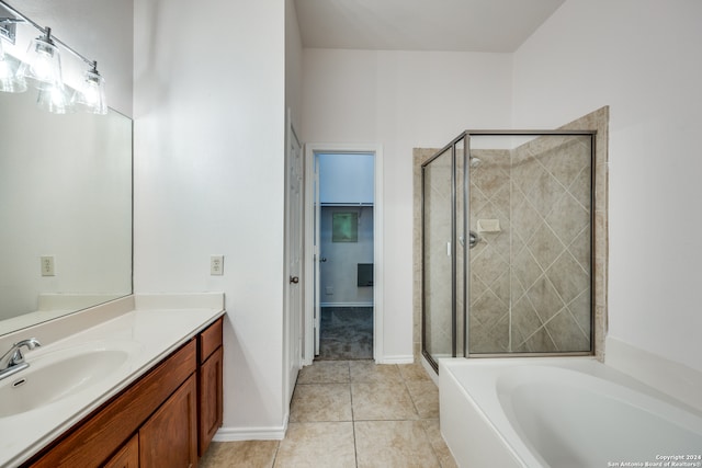 bathroom featuring tile patterned flooring, shower with separate bathtub, and vanity