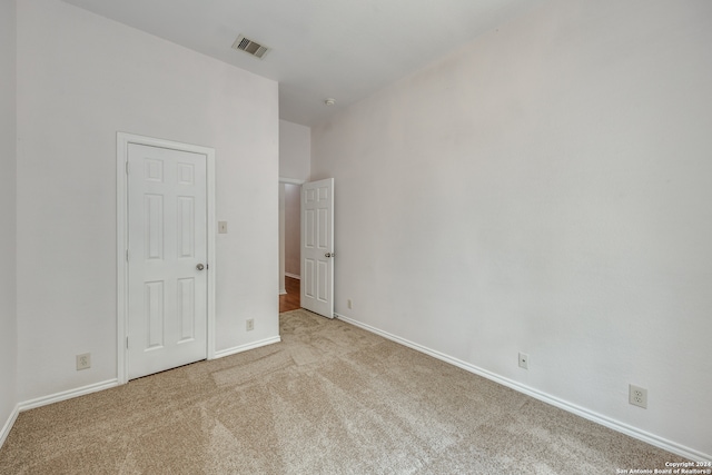 unfurnished bedroom with light carpet