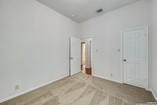 unfurnished room with light colored carpet