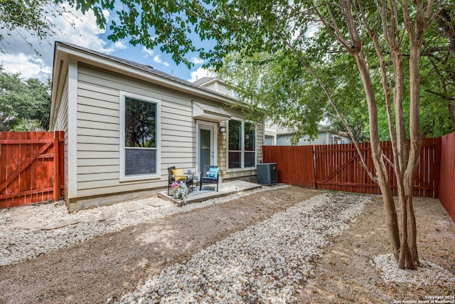 rear view of house featuring central AC and a patio