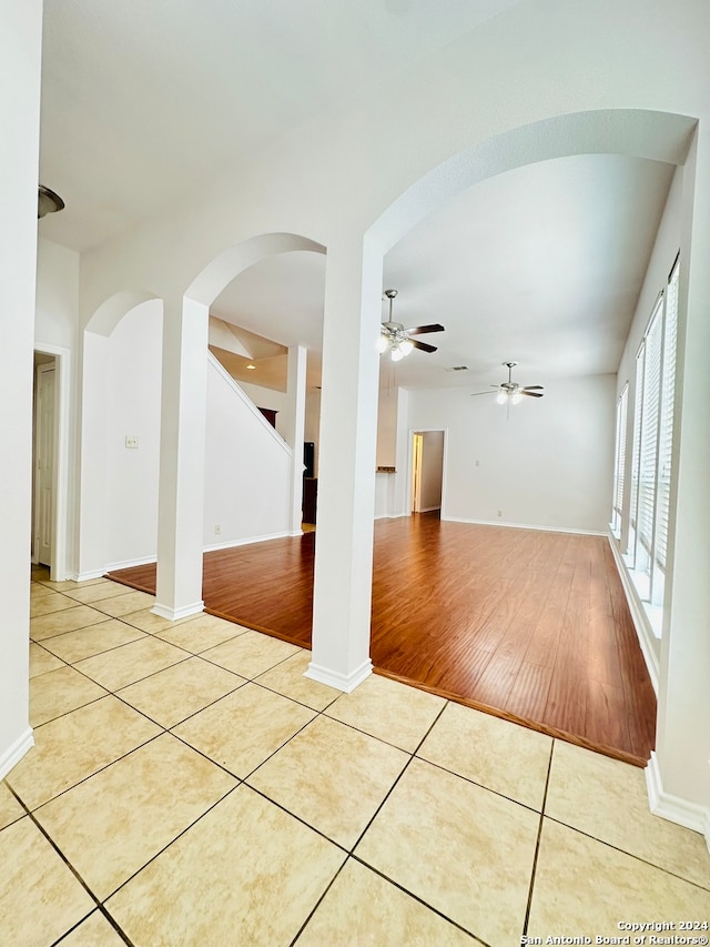 tiled empty room with ceiling fan