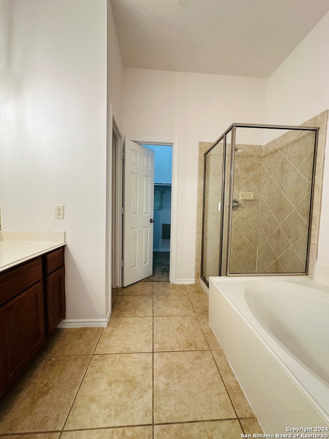 bathroom featuring tile patterned floors, shower with separate bathtub, and vanity