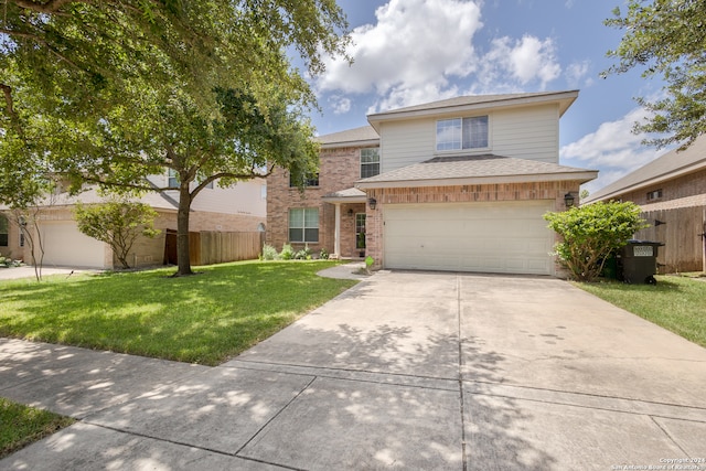 view of property with a garage and a front lawn