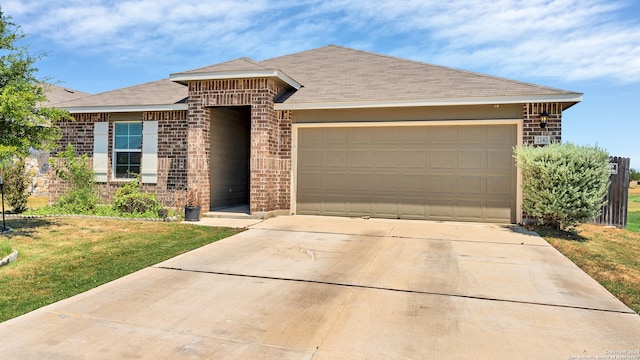 view of front of home featuring a front yard and a garage