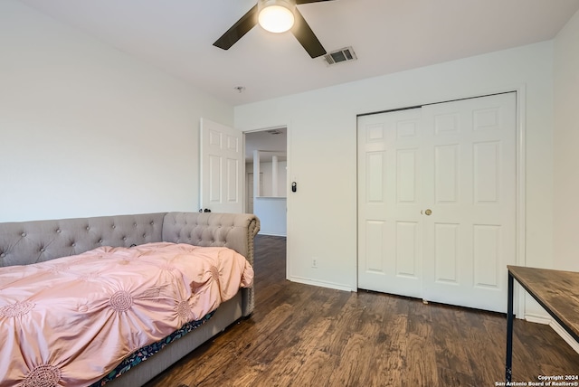 bedroom featuring ceiling fan, a closet, and dark wood-type flooring