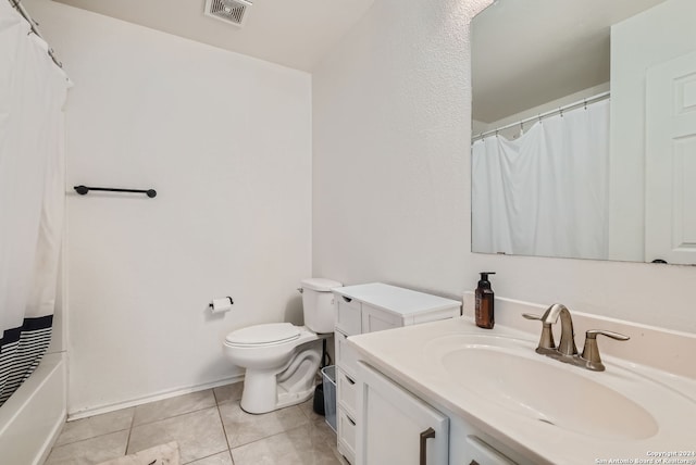 full bathroom featuring toilet, vanity, shower / bath combo with shower curtain, and tile patterned floors