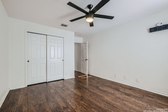 unfurnished bedroom featuring ceiling fan, wood-type flooring, and a closet