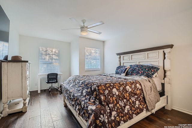 bedroom with dark hardwood / wood-style flooring and ceiling fan