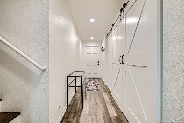 hallway with hardwood / wood-style flooring and a barn door