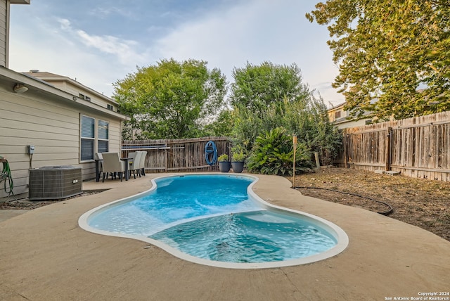 view of pool featuring central air condition unit and a patio