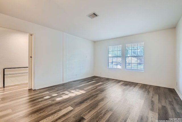 empty room with hardwood / wood-style flooring