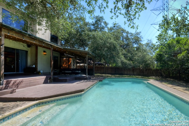 view of pool with a wooden deck