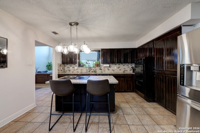 kitchen with decorative backsplash, dark brown cabinetry, stainless steel refrigerator with ice dispenser, and a kitchen island