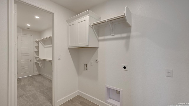 laundry room with cabinets, hookup for a gas dryer, washer hookup, hookup for an electric dryer, and light colored carpet