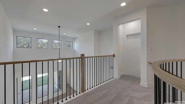 hallway featuring light colored carpet