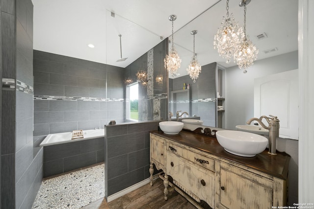 full bathroom with double vanity, tile walls, visible vents, and a sink