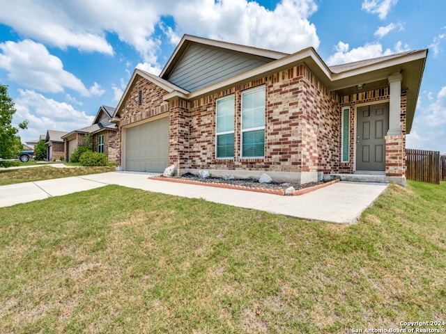 view of front of property featuring a front lawn and a garage