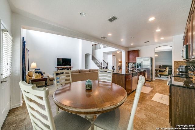 dining area with light tile patterned floors and sink