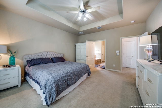 bedroom featuring a tray ceiling, ceiling fan, and light colored carpet