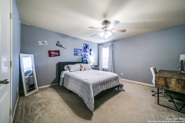 bedroom featuring a textured ceiling, carpet flooring, and ceiling fan