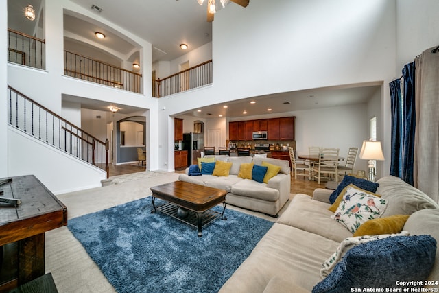 carpeted living room featuring a high ceiling