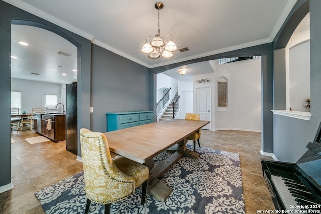 dining area with visible vents, arched walkways, stairway, an inviting chandelier, and crown molding