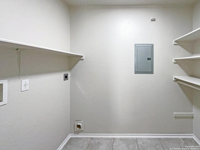 laundry area with laundry area, electric panel, baseboards, and electric dryer hookup