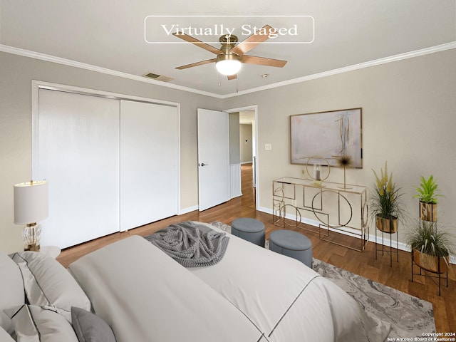 bedroom featuring a closet, visible vents, ornamental molding, wood finished floors, and baseboards