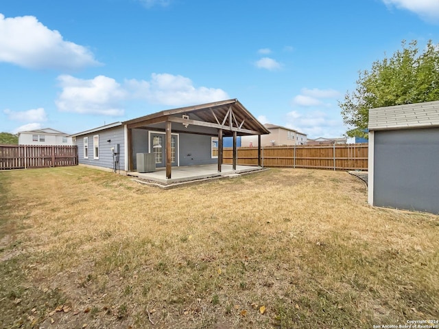 back of house with a patio, a yard, central AC unit, and a fenced backyard