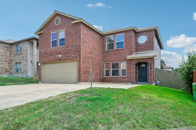 view of property with a garage and a front yard