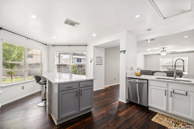 kitchen with sink, dark hardwood / wood-style floors, dishwasher, and ceiling fan