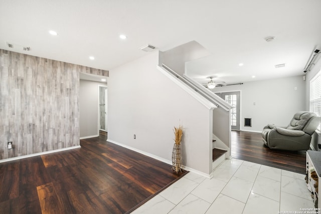 interior space with light tile patterned flooring, plenty of natural light, and ceiling fan