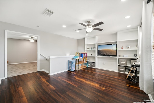 living room with ceiling fan, hardwood / wood-style flooring, and built in features