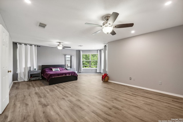 bedroom with ceiling fan and hardwood / wood-style flooring