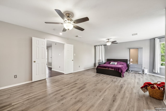 bedroom with ceiling fan and wood-type flooring