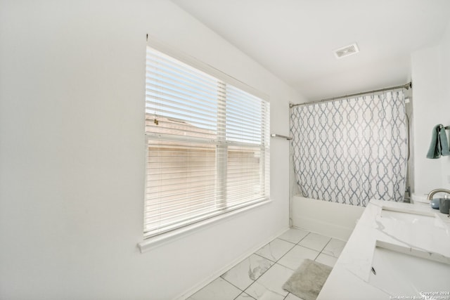 bathroom featuring tile patterned flooring, vanity, shower / tub combo with curtain, and a wealth of natural light