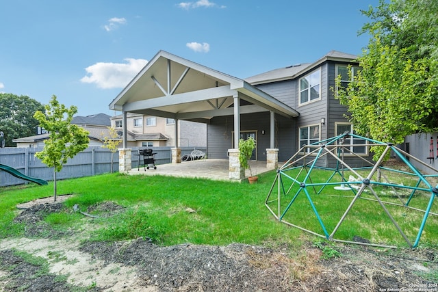 back of house with a patio and a lawn