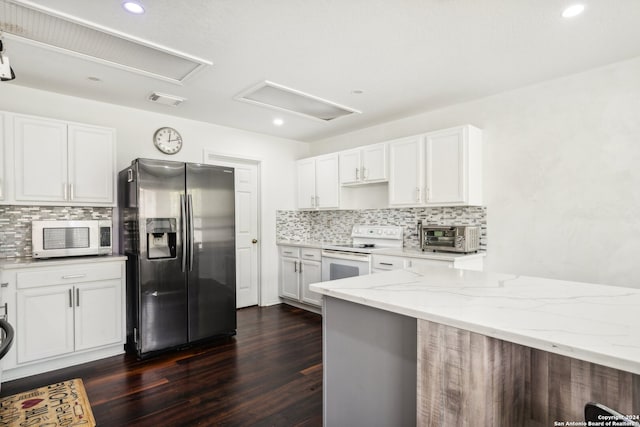 kitchen featuring backsplash, dark hardwood / wood-style flooring, light stone countertops, white cabinetry, and stainless steel appliances