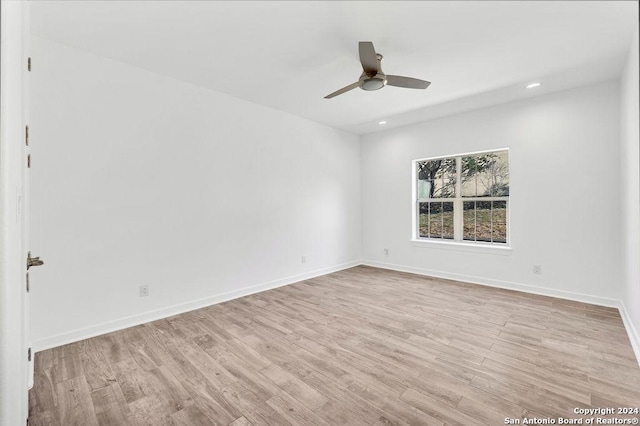 unfurnished room with a ceiling fan, light wood-type flooring, baseboards, and recessed lighting