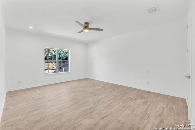 unfurnished room featuring light wood-style floors, baseboards, and a ceiling fan