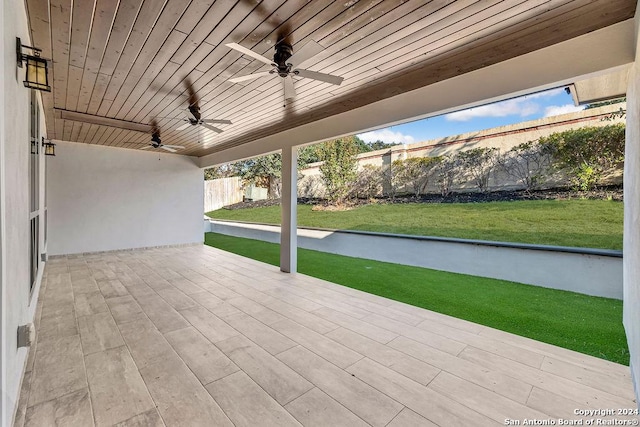 view of patio / terrace with ceiling fan and fence