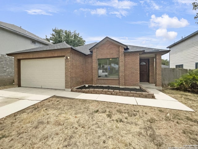 single story home with brick siding, driveway, an attached garage, and fence